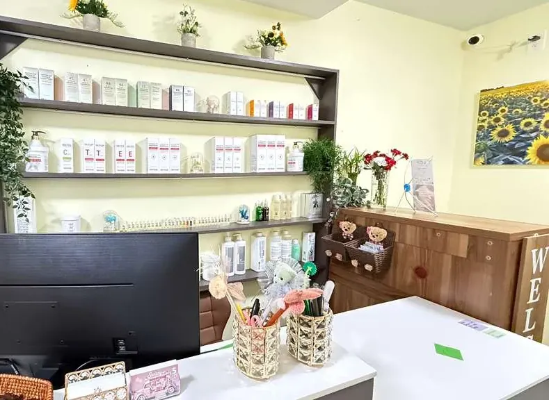 Korean skincare products displayed on shelves at the front desk